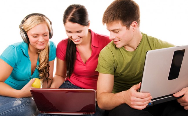 Group of students having fun, doing home work
